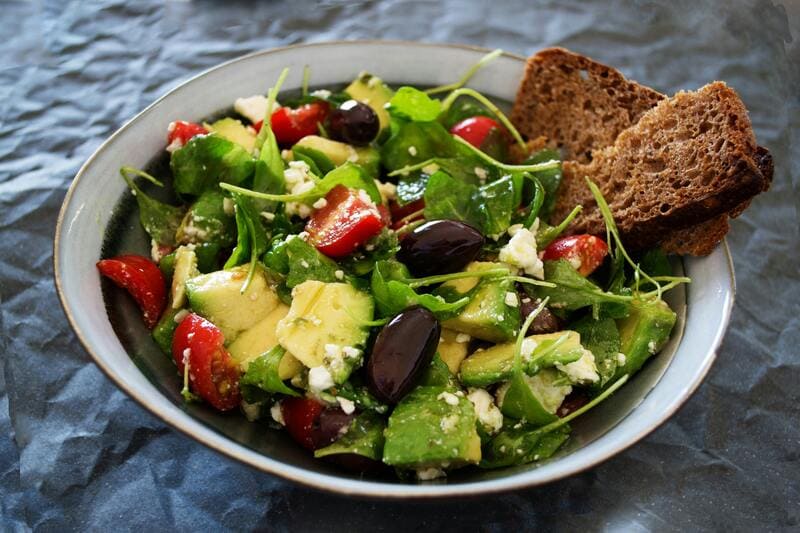 salade antioxydante composée de légumes colorés et tranche de pain complet 